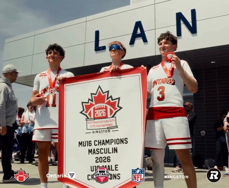 Jack Katsilieris, number 11, beside the 2026 U16 championship banner